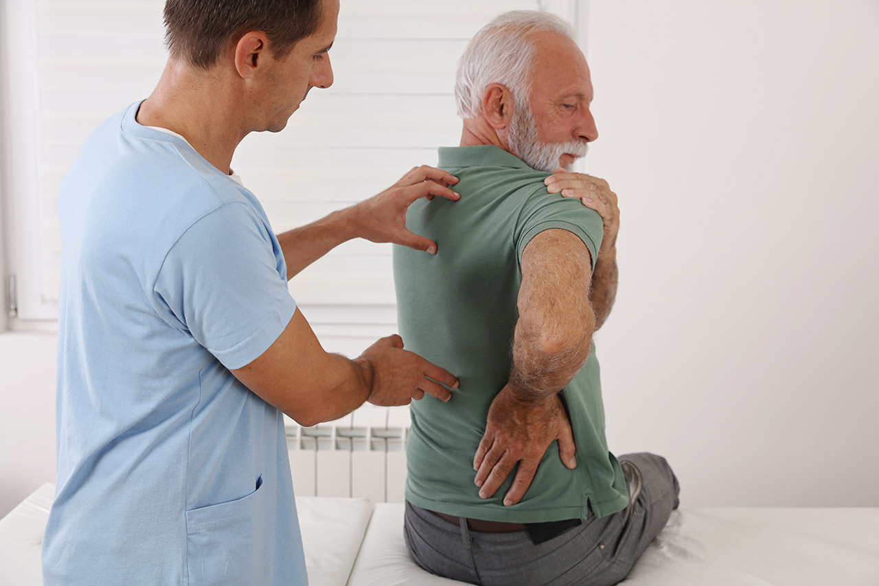 Doctor examining a patient in a medical exam room.